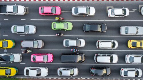 An aerial view shows cars and motorbikes packed in heavy traffic.