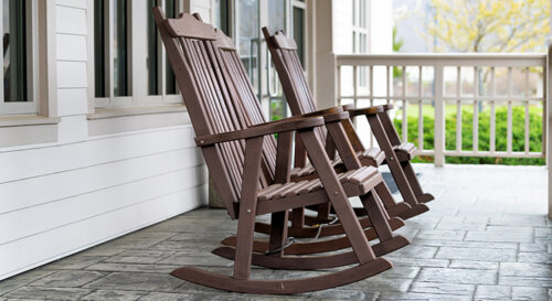 Front Porch Of House With Brown Rocking Chairs And Nobody In Traditional American House